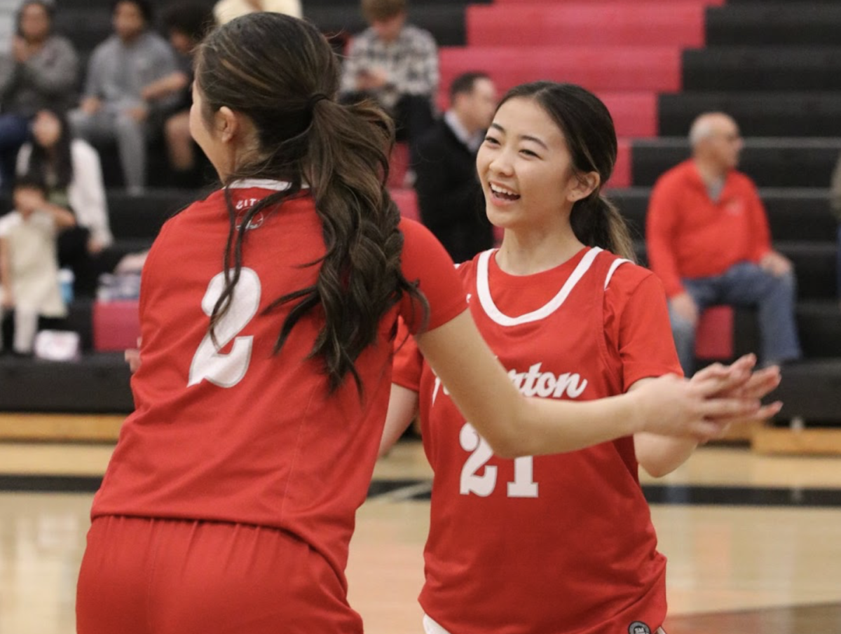 Senior Kaelyn Kawaguchi doing a handshake with her teammate sophomore Katey Kakimoto during the girls varsity basketball team’s pregame warmup.